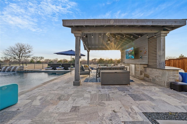 view of patio featuring ceiling fan, outdoor lounge area, fence, a gazebo, and a fenced in pool