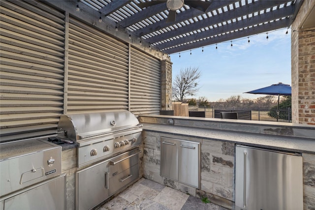 view of patio / terrace with a grill, fence, an outdoor kitchen, and a pergola