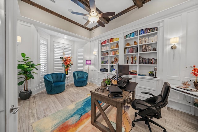 office space with ornamental molding, light wood-type flooring, a decorative wall, and ceiling fan