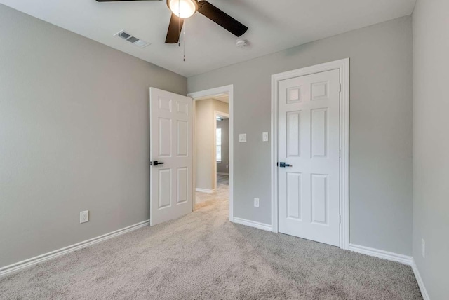 unfurnished bedroom with ceiling fan, carpet flooring, visible vents, and baseboards