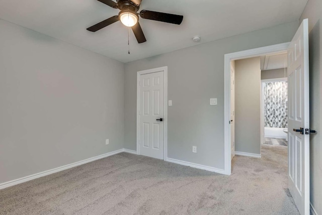 unfurnished bedroom with carpet flooring, a ceiling fan, and baseboards