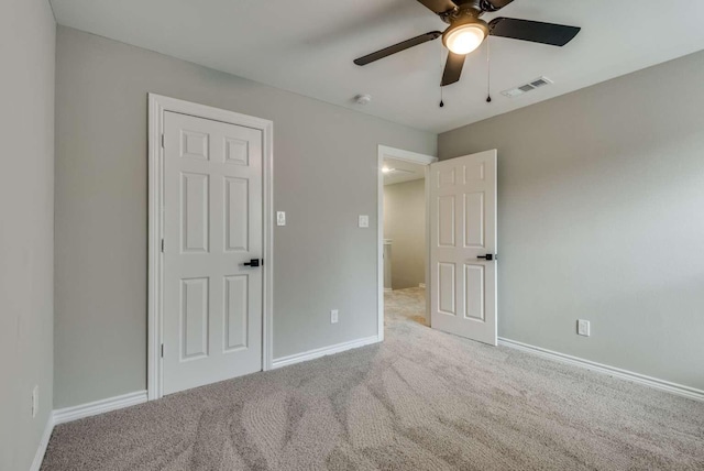 unfurnished bedroom featuring carpet floors, visible vents, ceiling fan, and baseboards