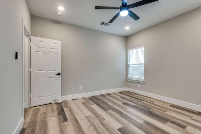 empty room featuring recessed lighting, a ceiling fan, visible vents, baseboards, and light wood-type flooring