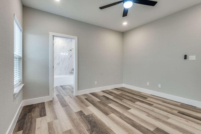 spare room featuring ceiling fan, recessed lighting, wood finished floors, and baseboards