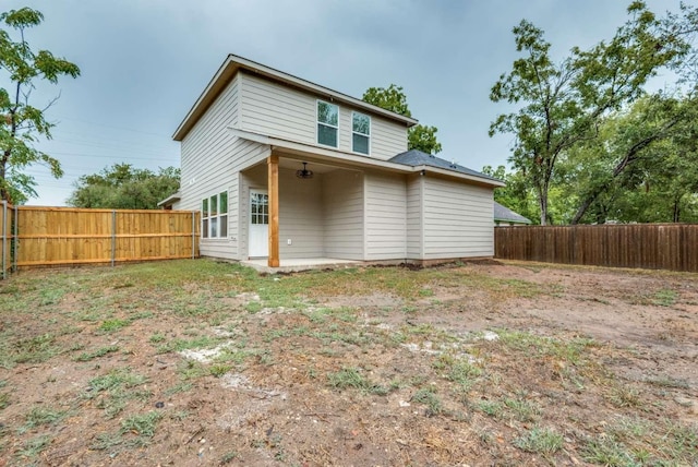 back of property featuring a fenced backyard