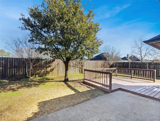 view of yard featuring a fenced backyard and a wooden deck