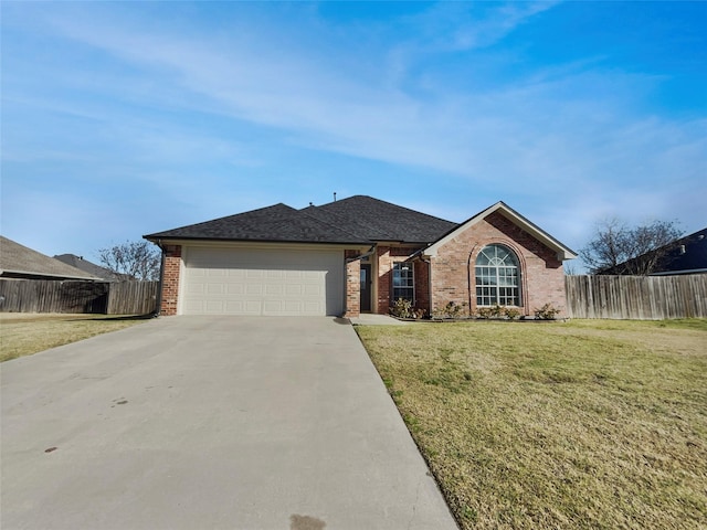 single story home with a garage, brick siding, fence, concrete driveway, and a front lawn