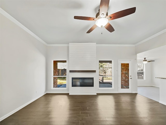 unfurnished living room featuring ornamental molding, a large fireplace, baseboards, and dark wood-style flooring