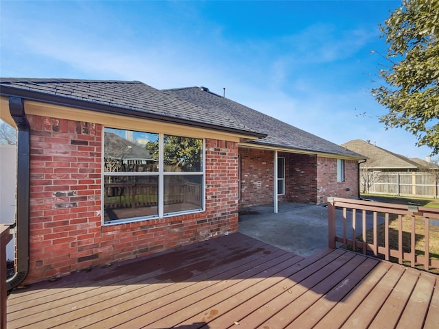 wooden deck featuring fence and a patio