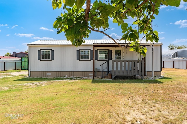 manufactured / mobile home with crawl space, fence, metal roof, and a front yard