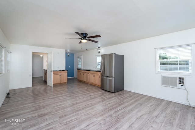 kitchen with light wood-style floors, baseboards, a wealth of natural light, and freestanding refrigerator