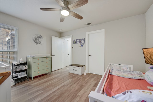 bedroom featuring ceiling fan, light wood-style flooring, and visible vents