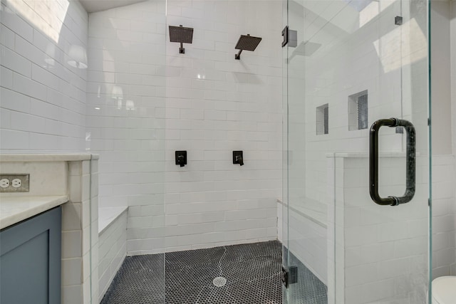 bathroom featuring a stall shower and vanity