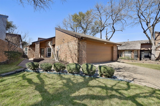 view of property exterior featuring driveway, a garage, a lawn, and brick siding