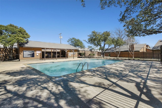 community pool featuring a patio area and fence