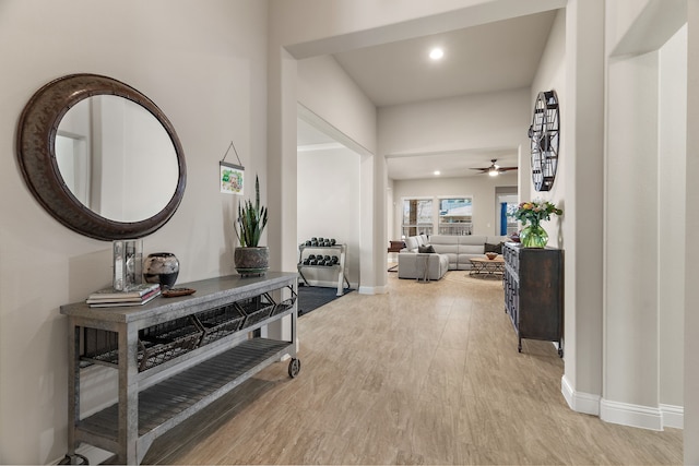 hallway with recessed lighting, light wood-style flooring, and baseboards