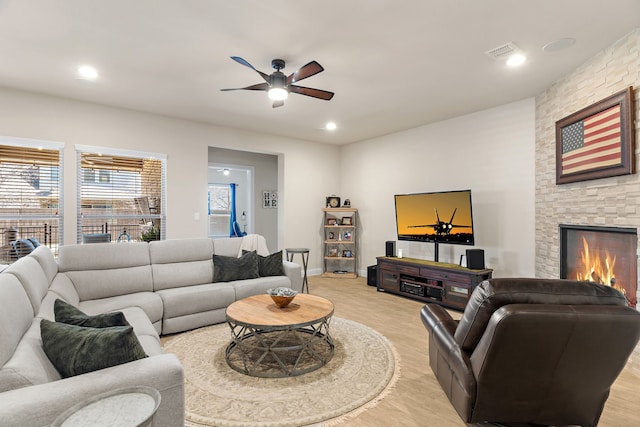 living room featuring a fireplace, recessed lighting, visible vents, light wood-style floors, and ceiling fan