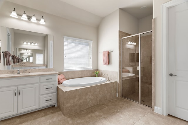 bathroom with a stall shower, vanity, a bath, and tile patterned floors