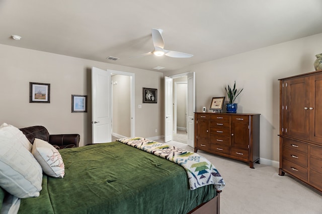 bedroom featuring light carpet, a ceiling fan, visible vents, and baseboards