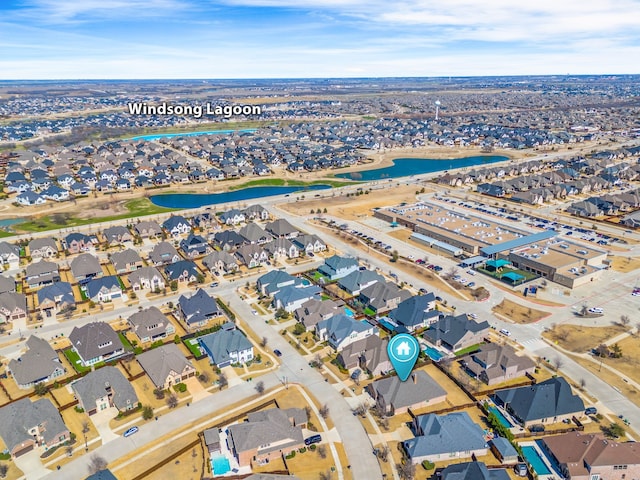 birds eye view of property with a water view and a residential view