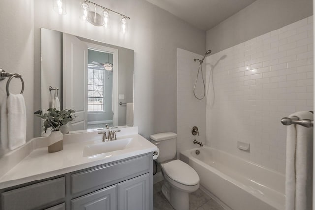 bathroom featuring washtub / shower combination, vanity, toilet, and tile patterned floors