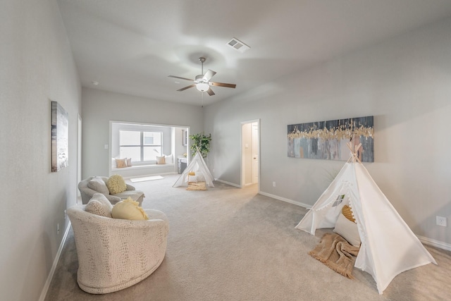 interior space featuring carpet floors, a ceiling fan, visible vents, and baseboards