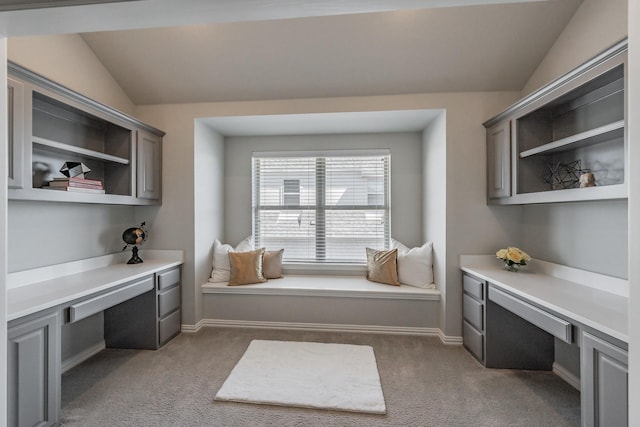 office with baseboards, vaulted ceiling, dark colored carpet, and built in study area