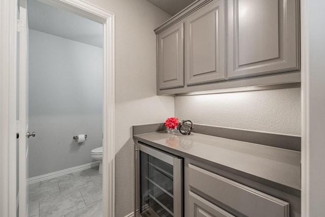 interior space featuring wine cooler and baseboards