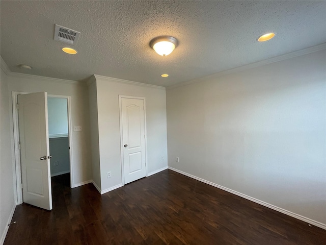 unfurnished bedroom with baseboards, visible vents, wood finished floors, crown molding, and a textured ceiling