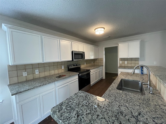 kitchen with white cabinetry, visible vents, appliances with stainless steel finishes, and a sink