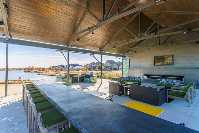 view of patio / terrace with a water view and an outdoor living space