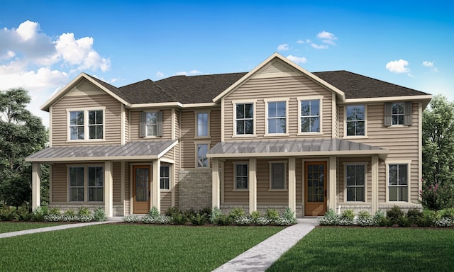 view of front of home featuring a standing seam roof, metal roof, a porch, and a front yard