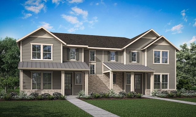 view of front of home featuring brick siding, metal roof, roof with shingles, a standing seam roof, and a front yard