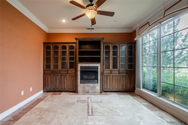 unfurnished living room with a wealth of natural light, ornamental molding, visible vents, and baseboards