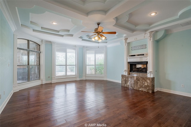 unfurnished living room featuring a high end fireplace, dark wood finished floors, baseboards, and ceiling fan