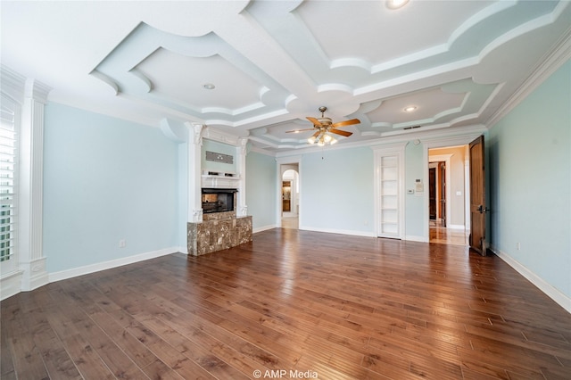 unfurnished living room with baseboards, ceiling fan, ornamental molding, dark wood-type flooring, and a multi sided fireplace