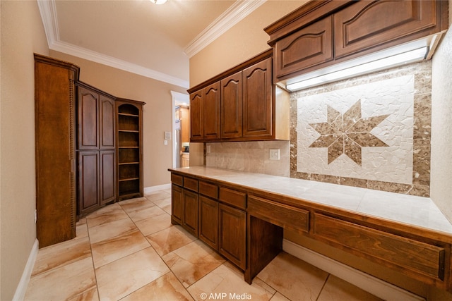 kitchen with tile countertops, open shelves, decorative backsplash, ornamental molding, and baseboards