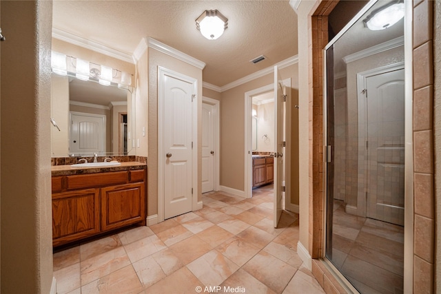 bathroom with a stall shower, visible vents, vanity, a textured ceiling, and crown molding