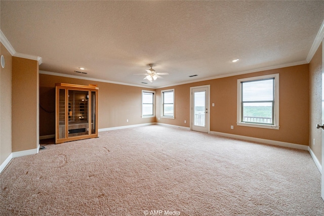 unfurnished living room featuring ornamental molding, visible vents, light carpet, and a textured ceiling