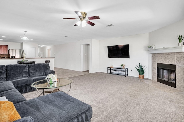 carpeted living room with ceiling fan, recessed lighting, visible vents, and a tile fireplace