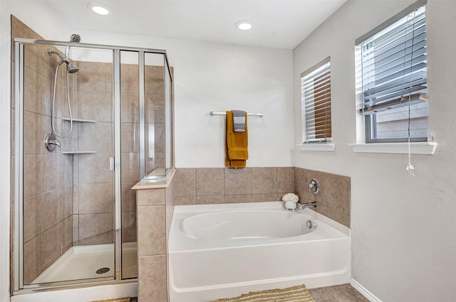 full bath with a shower stall, a garden tub, and recessed lighting