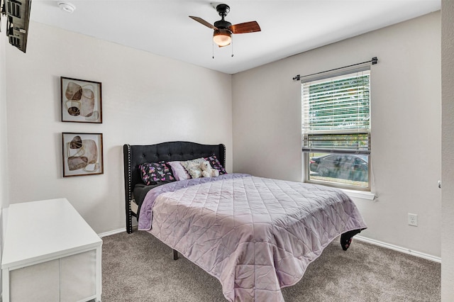 carpeted bedroom with baseboards and a ceiling fan