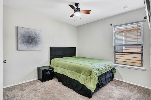 carpeted bedroom featuring baseboards and ceiling fan