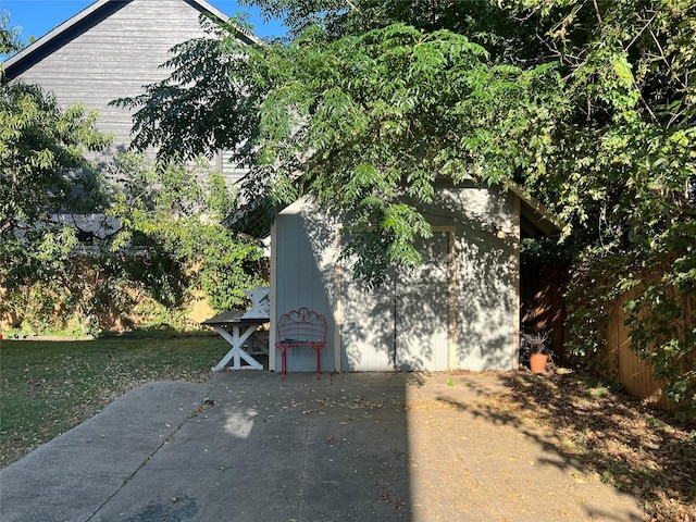 view of side of property featuring a patio area and a lawn