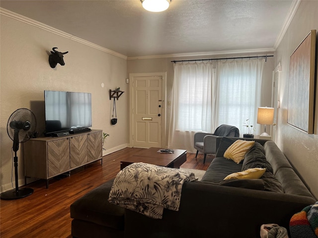 living room with baseboards, a textured ceiling, wood finished floors, and crown molding