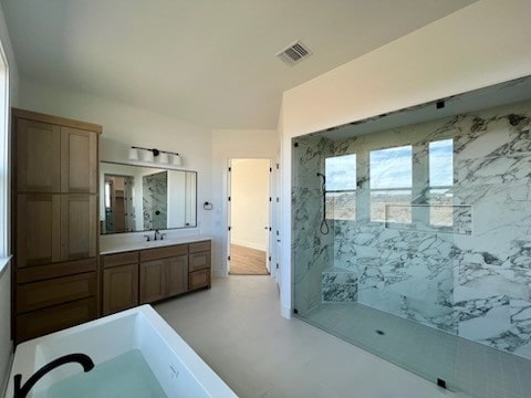 bathroom with visible vents, vanity, and a marble finish shower