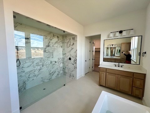 full bathroom with a marble finish shower, vanity, and a tub