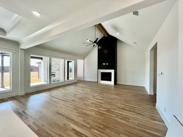 unfurnished living room featuring baseboards, a fireplace, a ceiling fan, and wood finished floors