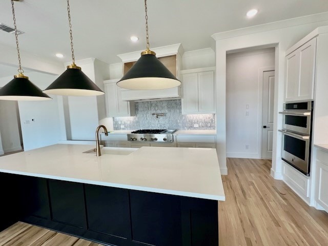 kitchen with tasteful backsplash, visible vents, stainless steel double oven, crown molding, and a sink