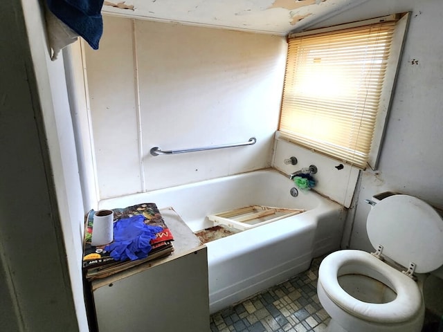 full bathroom featuring toilet and a bath